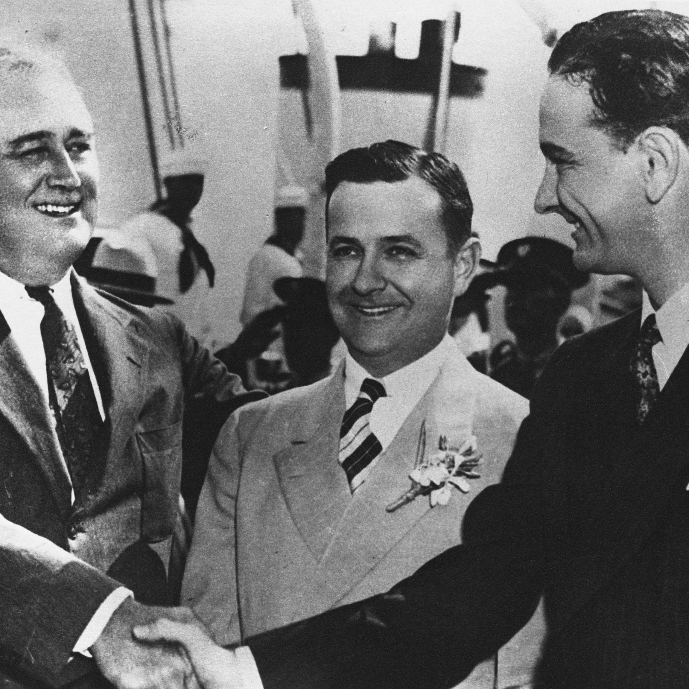 President Franklin Delano Roosevelt shakes Congressman Lyndon B. Johnson's hand, while Governor Allred stands behind them.